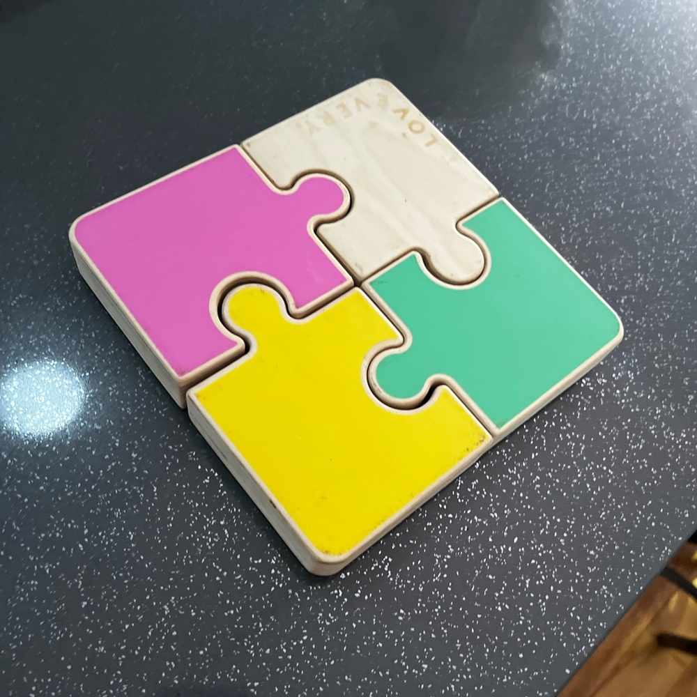 Wooden 4-Piece Puzzle Toy in Pink, Yellow, Green, and Natural
